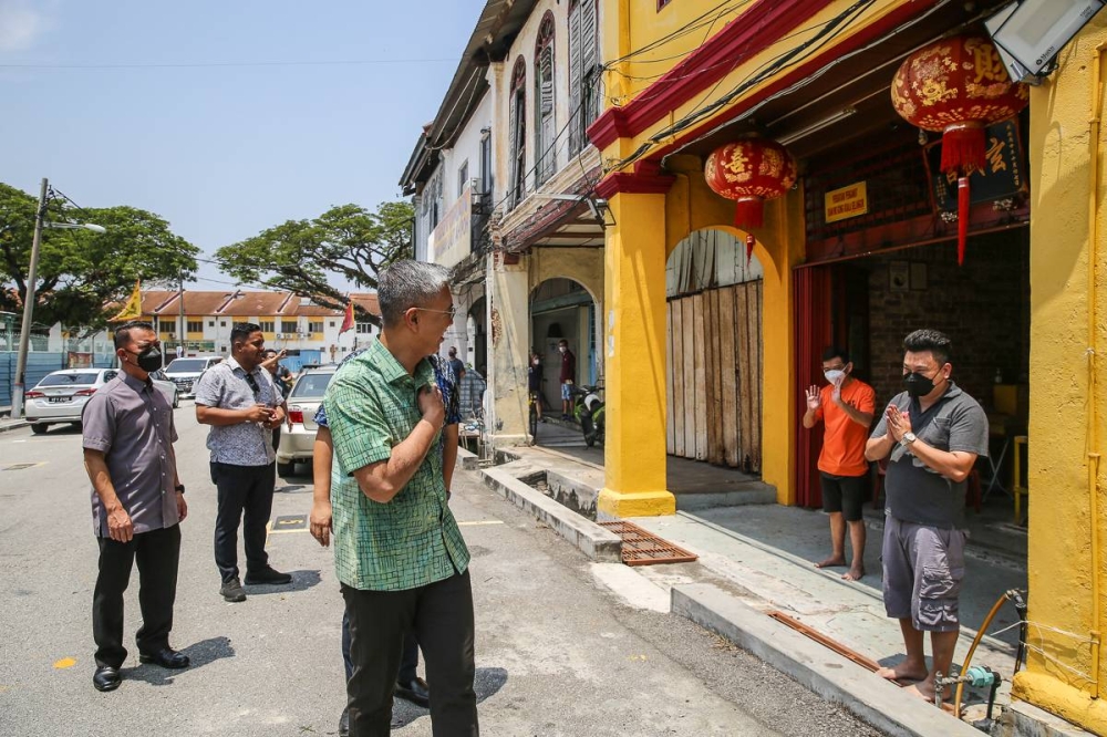 Finance Minister Datuk Seri Tengku Zafrul Abdul Aziz talks with people as he walks along Jalan Raja Abdullah in Kuala Selangor, August 14, 2022. — Picture by Yusof Mat Isa