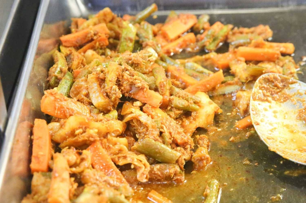 A signature item is their 'achar' where crunchy vegetables are tossed in the finely ground spice paste and peanuts.