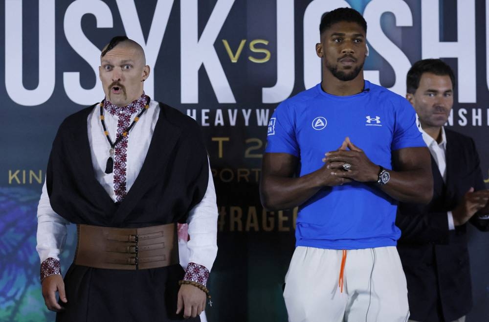 Oleksandr Usyk, Anthony Joshua and promoter Eddie Hearn during the press conference in Jeddah, Saudi Arabia, August 17, 2022. — Action Images pic via Reuters