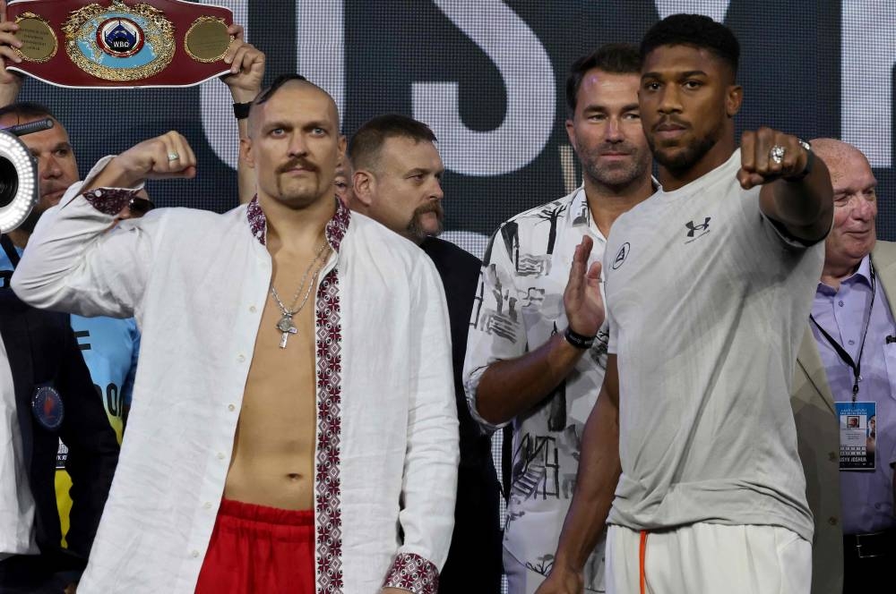 Ukraine’s Oleksandr Usyk and Britain’s Anthony Joshua gesture during a public weighing ahead of the heavyweight boxing rematch for the WBA, WBO, IBO and IBF titles between them, in the Saudi Red Sea city of Jeddah, August 19, 2022. — AFP pic 