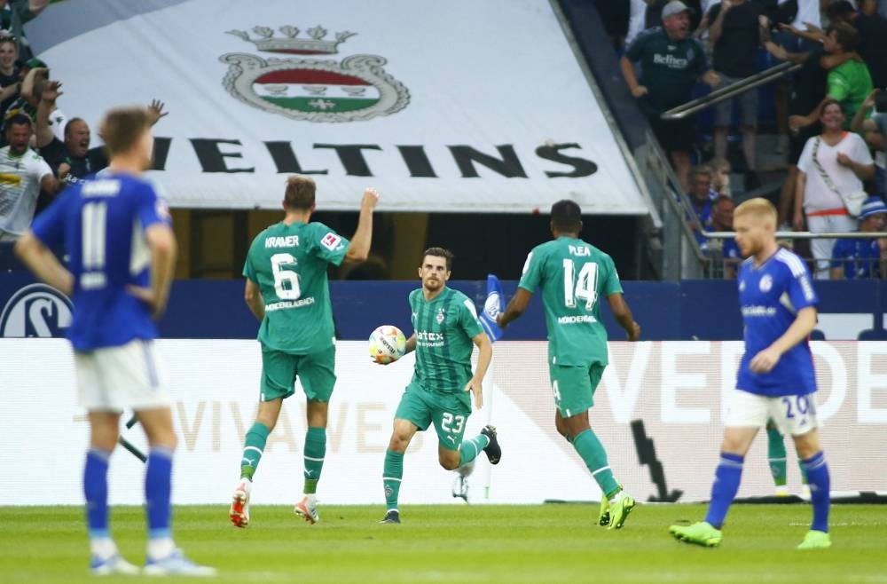 Borussia Moenchengladbach's Jonas Hofmann celebrates scoring their first goal with Alassane Plea and Christoph Kramer. — Reuters pic