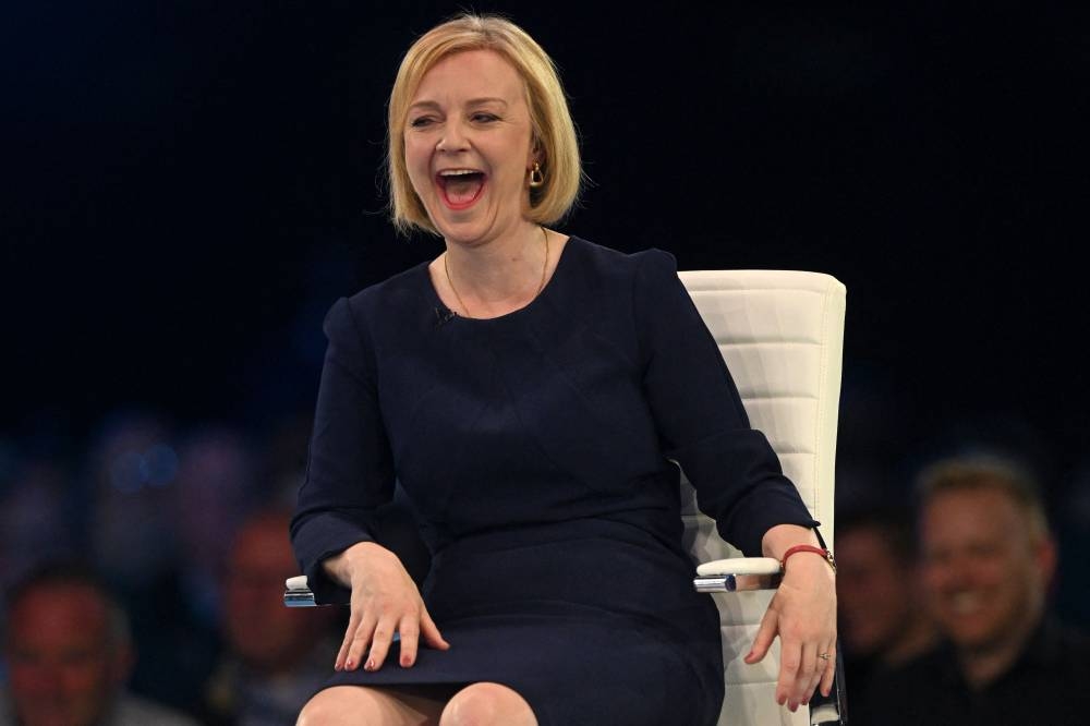 Contender to become the country’s next Prime minister and leader of the Conservative party British Foreign Secretary Liz Truss smiles during a Conservative Party Hustings event in Manchester, north-west England, on August 19, 2022. — AFP pic