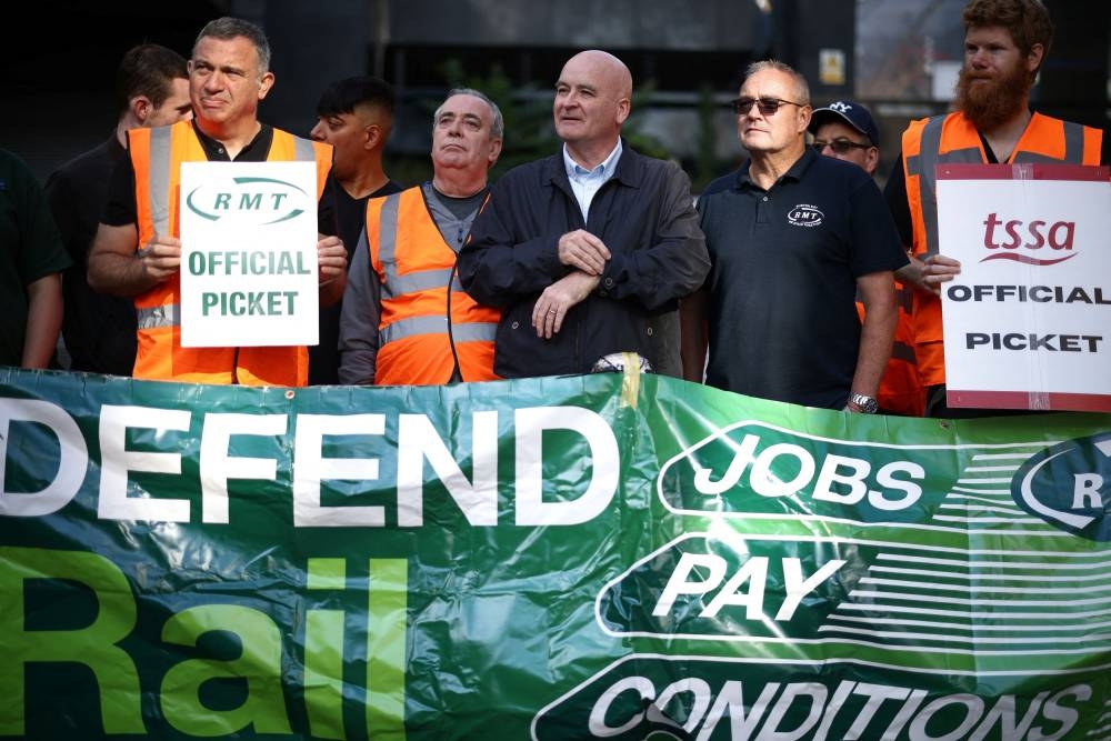 Mick Lynch, General Secretary of the National Union of Rail, Maritime and Transport Workers joins other union members on strike at a picket line outside Euston railway station in London, Britain, August 20, 2022. — Reuters pic