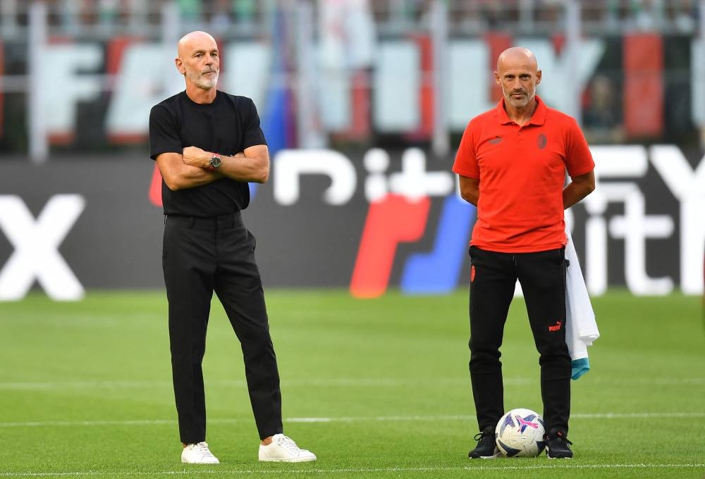 File photo of AC Milan coach Stefano Pioli with assistant coach Giacomo Murelli before the match against Udinese at the San Siro Stadium, August 13, 2022. — Reuters pic