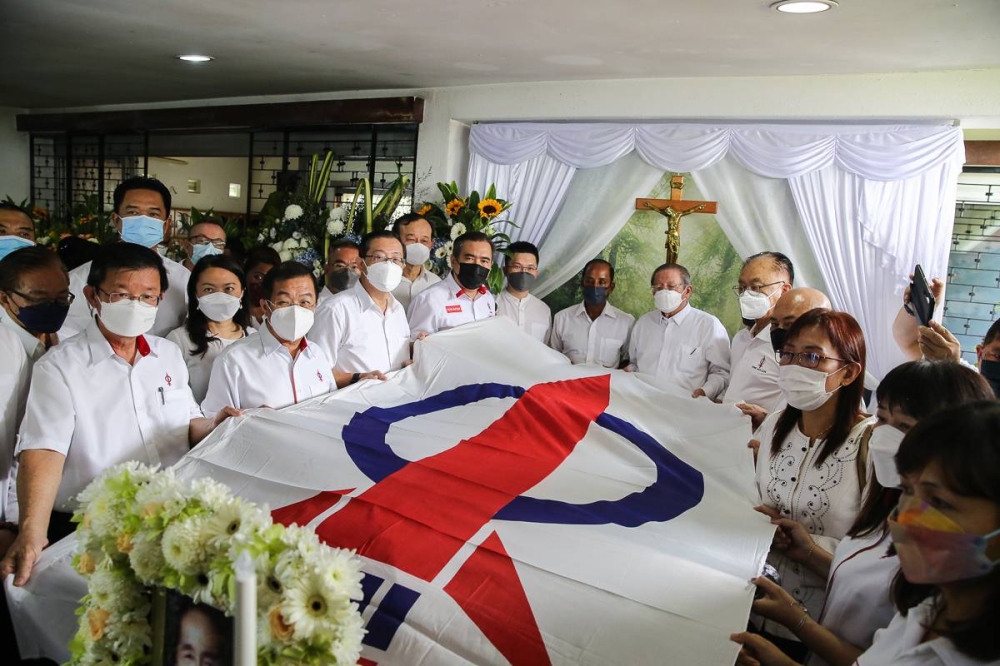 DAP leaders put party flag on the coffin of DAP founding chairman Dr Chen Man Hin during the funeral ceremony at his residence in Seremban August 21, 2022. — Picture by Yusof Mat Isa