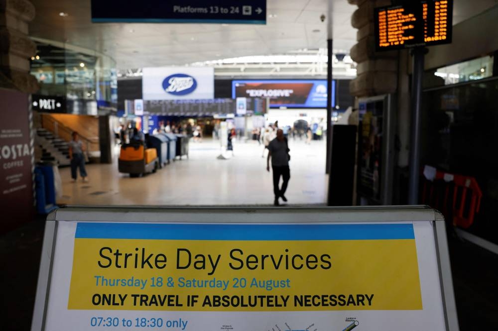 A message board warns of travel disruption at Waterloo Station in London on August 18, 2022 as Britain's train network faced further heavy disruption in major walkouts that follow the sector's biggest strike action for 30 years already this summer. Railway and postal staff, dockers joined the strikes too. — AFP pic