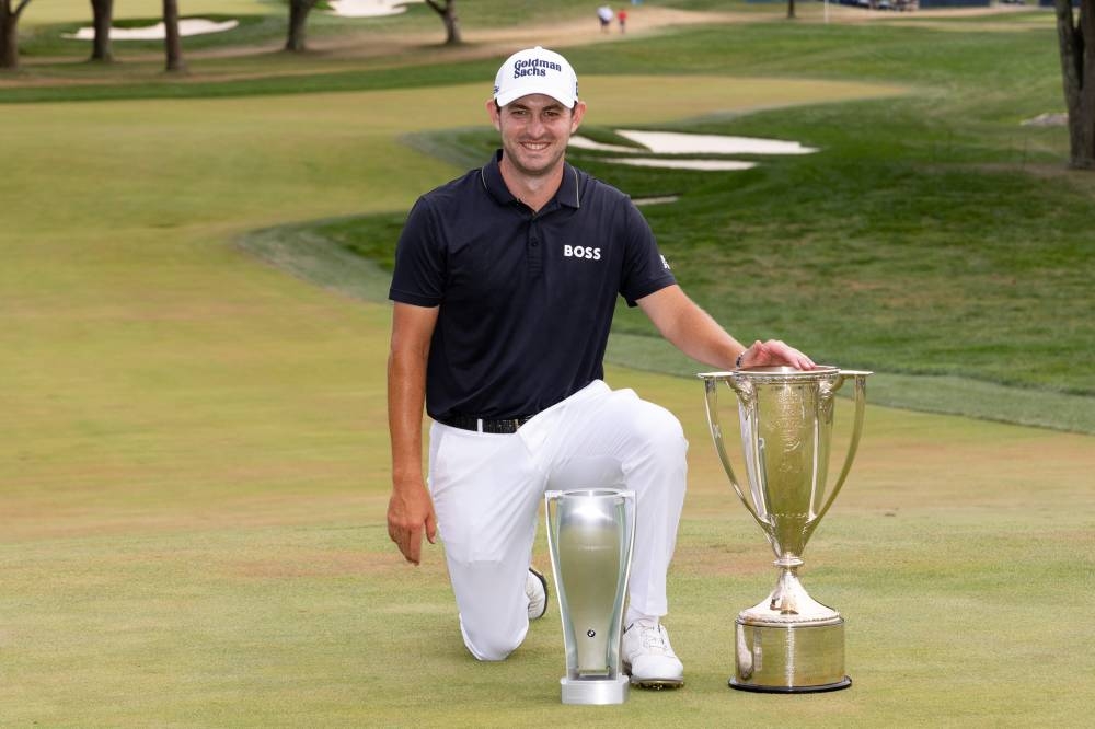 Patrick Cantlay posses with the trophies after winning the BMW Championship golf tournament in Wilmington August 21, 2022. — Reuters pic
