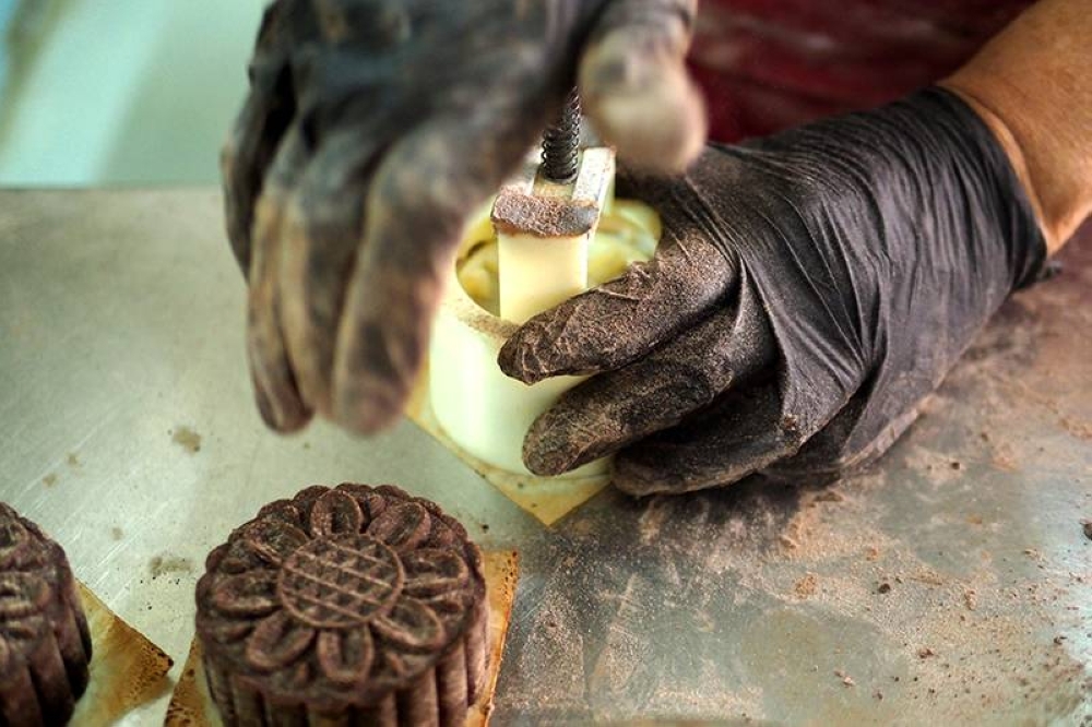The mooncakes are pressed out using plastic moulds that give a more intricate design.