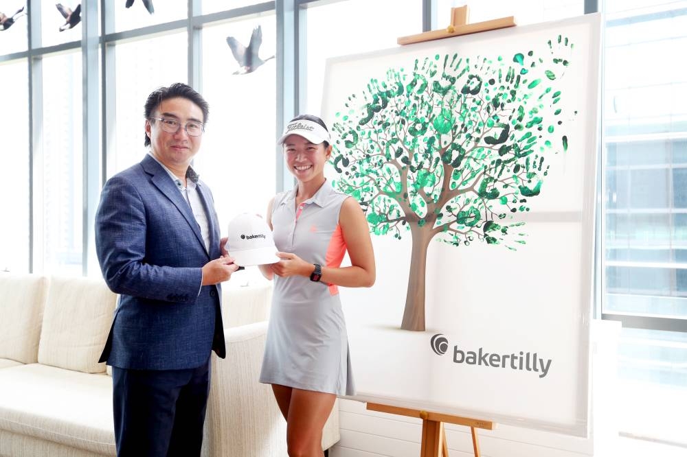 Baker Tilly Malaysia’s group managing partner Andrew Heng (left) with Malaysian golfer Genevieve Ling. The firm will be supporting Ling's dream to reach the LPGA Tour. — Photo courtesy of Baker Tilly Malaysia