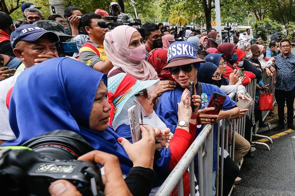 Supporters shed tears after hearing the verdict of Datuk Seri Najib Razak at the Palace of Justice, August 23, 2022. — Picture by Sayuti Zainudin