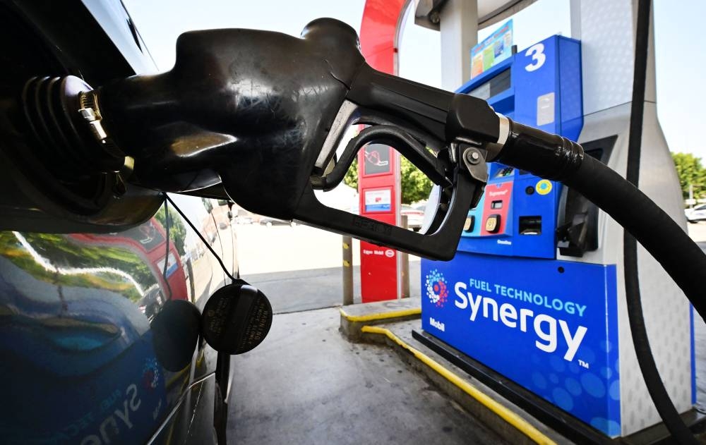 A gasoline nozzle pumps gas into a vehicle in Los Angeles, California August 23, 2022. — Reuters pic