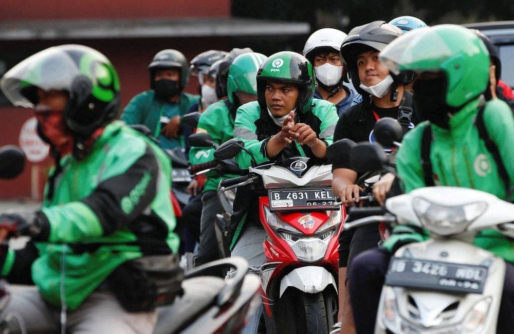 Motorcycle drivers wait in line to buy subsidised fuel at a petrol station of the state-owned company Pertamina, in Jakarta, Indonesia, August 22, 2022. — Reuters pic