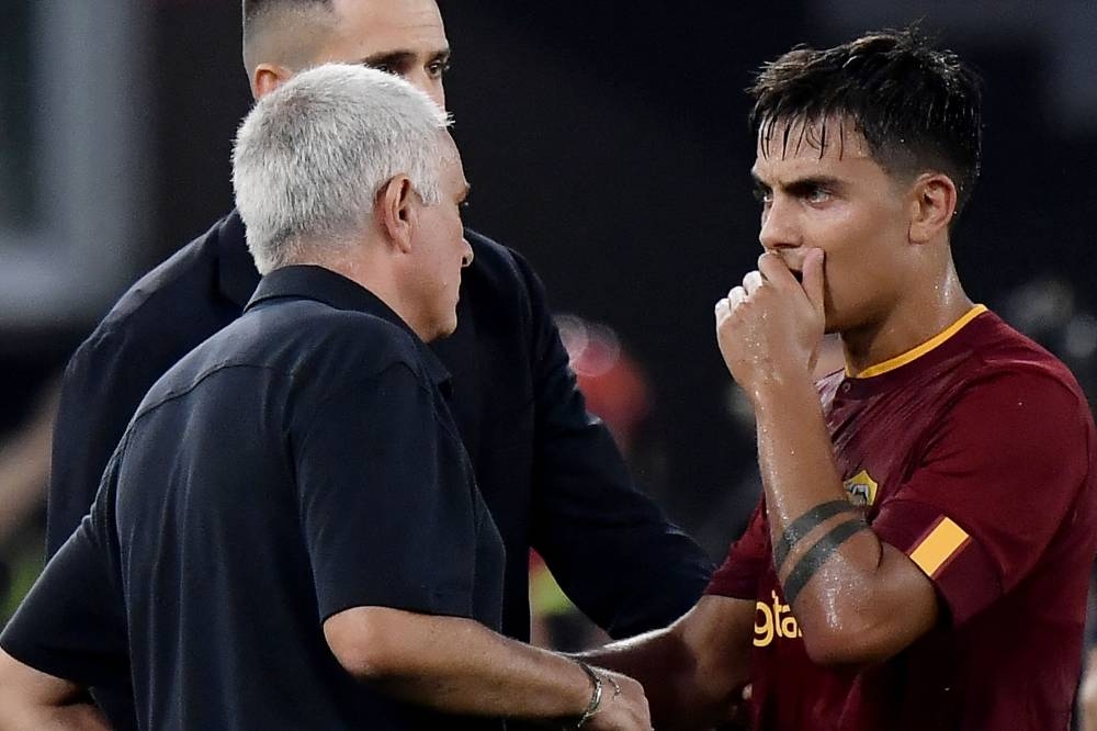 AS Roma coach Jose Mourinho speaks with his Argentinian forward Paulo Dybala during the Italian Serie A match against Cremonese at the Olympic Stadium in Rome, August 22, 2022. — AFP pic 