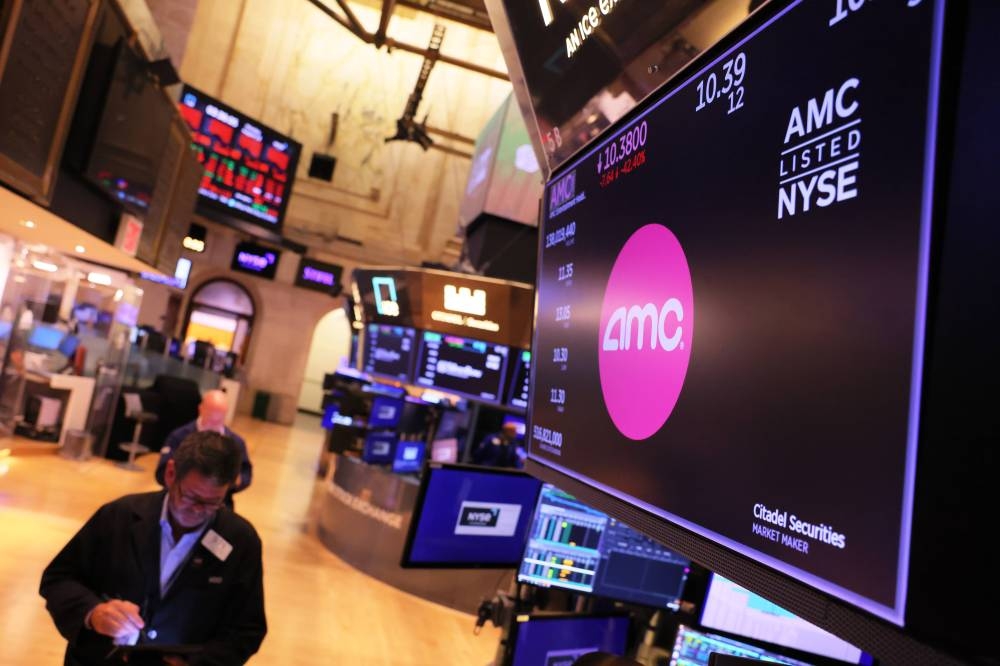 The AMC company logo is displayed as traders work on the floor of the New York Stock Exchange during afternoon trading on August 22, 2022 in New York City. The Dow Jones dropped over 600 points today as U.S. stocks continue to fall ahead of Federal Reserve Chairman Jerome Powell upcoming talk on inflation at the central bank annual Jackson Hole economic symposium. — AFP pic