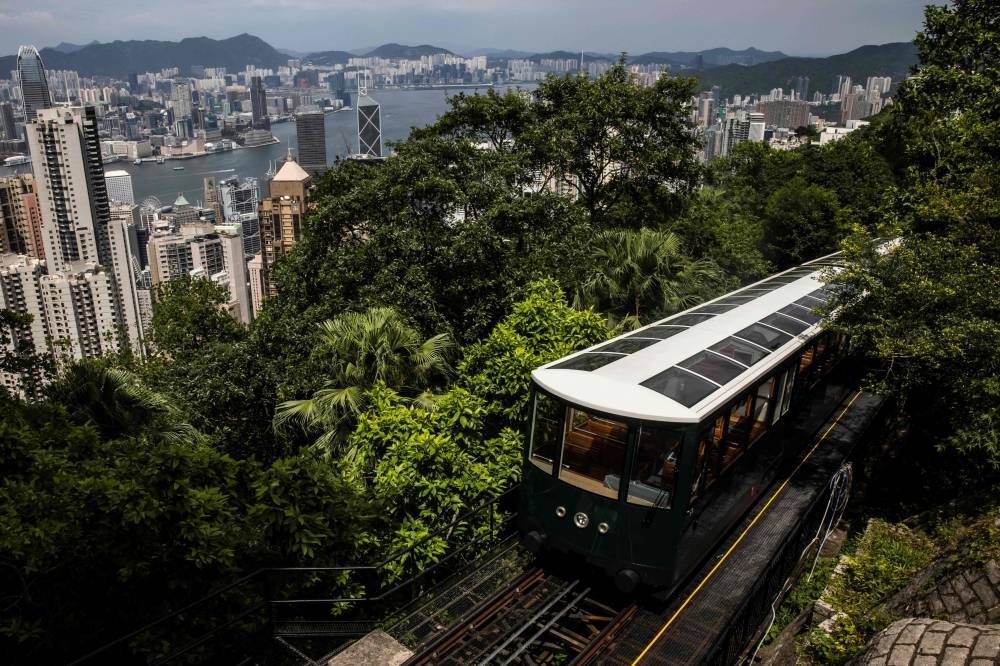 The Peak Tram is seen in front of the Hong Kong skyline on August 24, 2022. — AFP pic