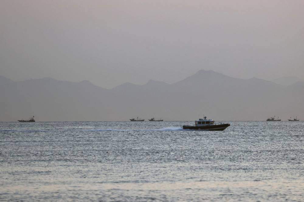 File photo of a Taiwan Coast Guard ship travelling past the coast of China, in the waters off Nangan island of Matsu archipelago in Taiwan August 16. — Reuters pic