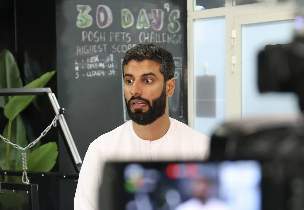 Mansour Hammadi, the owner of 'Posh Pets' boutique and spa, speaks during an interview at the establishment in Abu Dhabi on August 16, 2022. — AFP pic