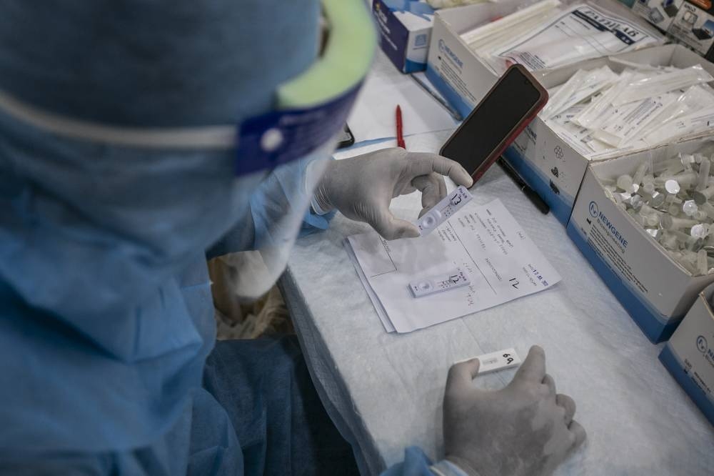 People take the Covid-19 screening test due to the increasing positive numbers, at Clinic Anda Kota Damansara on July 10, 2022. — Picture by Hari Anggara