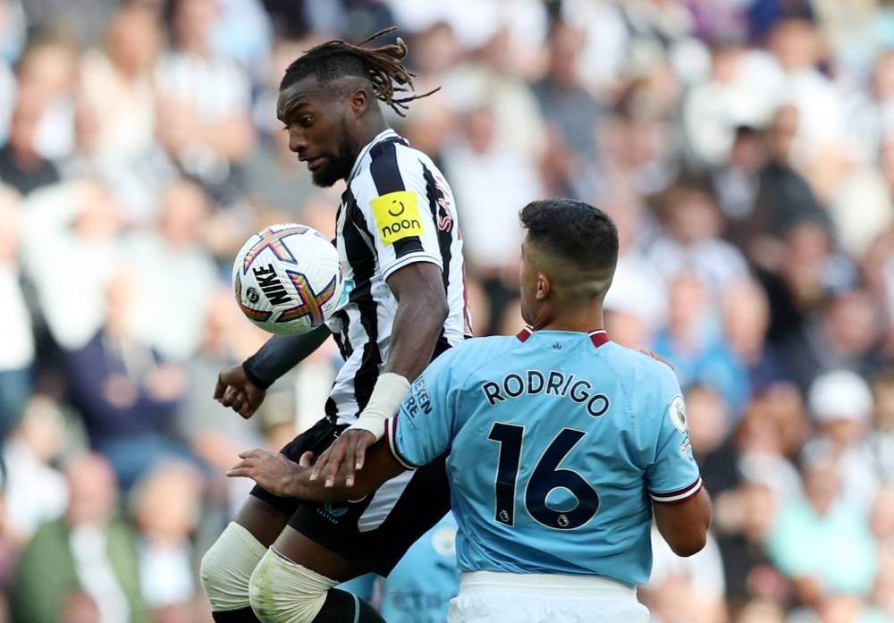 Newcastle United's Allan Saint-Maximin in action with Manchester City's Rodri during the Newcastle United v Manchester City match at  St James' Park, Newcastle, Britain - August 21, 2022. — Reuters pic