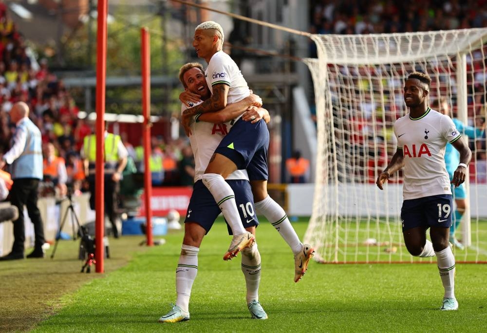 Tottenham Hotspur's Harry Kane celebrates scoring their second goal with Richarlison and Ryan Sessegnon at The City Ground, Nottingham August 28, 2022. — Reuters pic