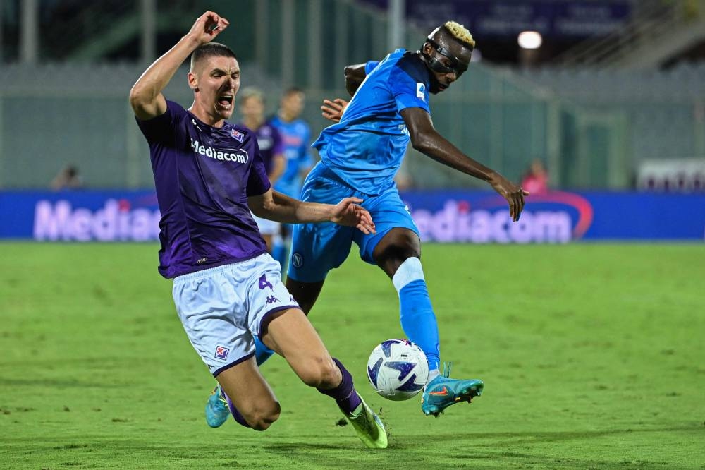 Napoli's Victor Osimhen (right) challenges Fiorentina defender Nikola Milenkovic at the Artemio-Franchi stadium in Florence August 28, 2022. — AFP pic