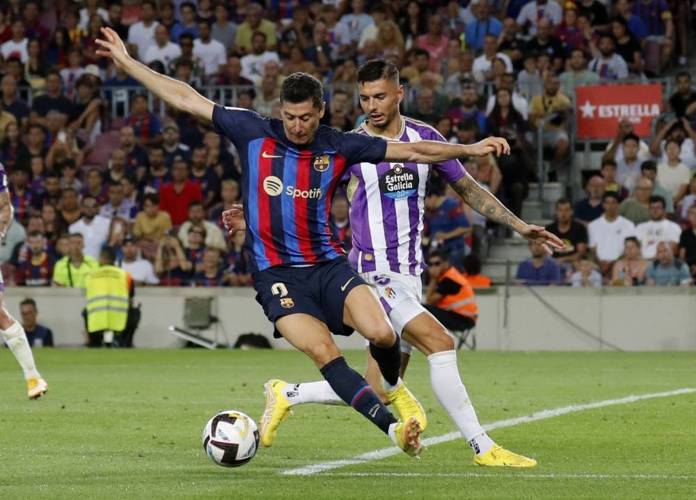 Barcelona's Robert Lewandowski in action with Real Valladolid's Javi Sanchez at Camp Nou, Barcelona August 28, 2022. — Reuters pic 