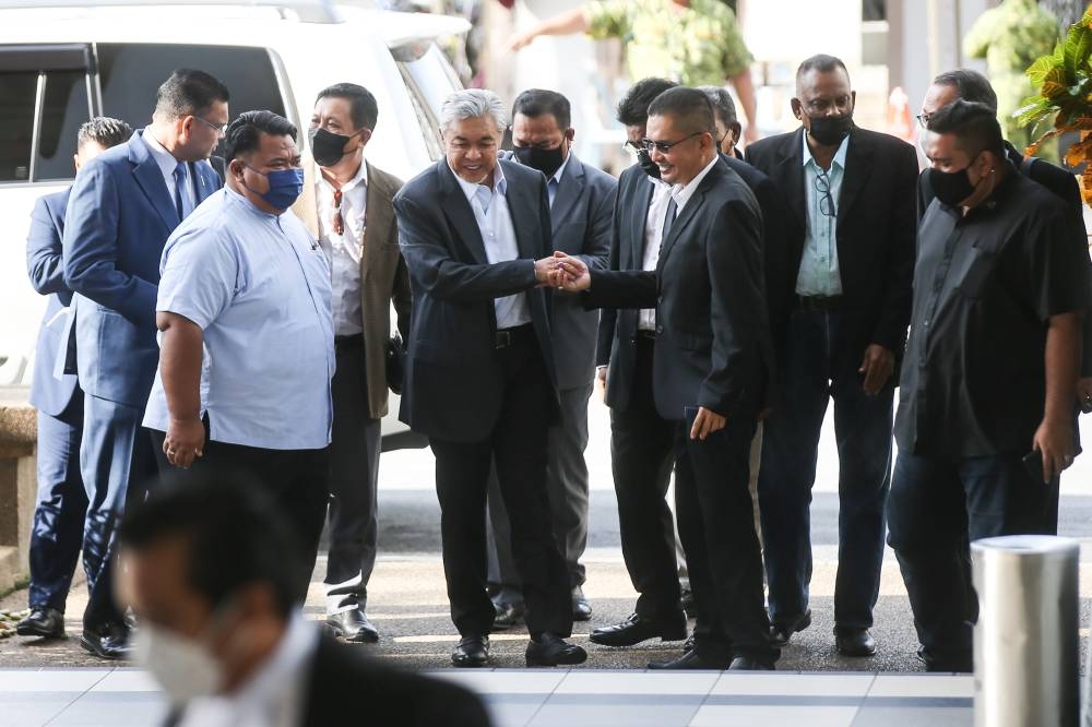 Datuk Seri Ahmad Zahid Hamidi (centre) arrives at Kuala Lumpur High cCourt August 29, 2022. — Picture by Ahmad Zamzahuri
