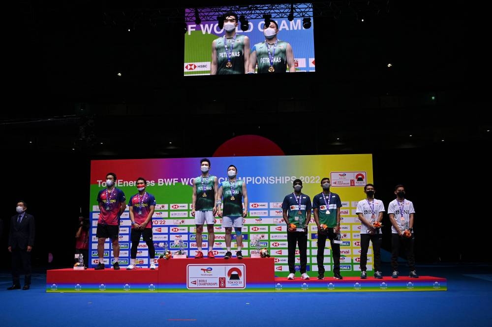 Gold medal winners Aaron Chia and Soh Wooi Yik (2nd left pair) of Malaysia pose on the podium with silver medallists Mohammad Ahsan and Hendra Setiawan of Indonesia (left pair) and bronze medallists Muhammad Rian Ardianto and Fajar Alfian of Indonesia (right pair) and Chirag Shetty and Satwiksairaj Rankireddy of India (2nd right pair) after the men's doubles final match at the World Badminton Championships in Tokyo on August 28, 2022. — AFP pic