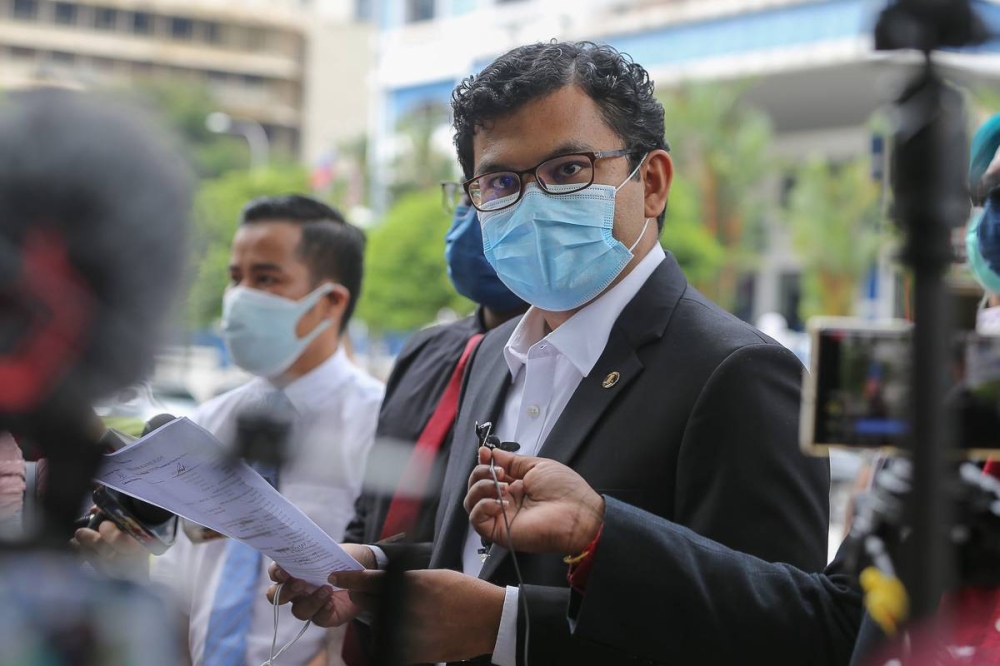 Johor Baru MP Akmal Nasrullah Nasir speaks to reporters in front of the Dang Wangi district police headquarters in Kuala Lumpur August 2, 2021. — Picture by Yusof Mat Isa