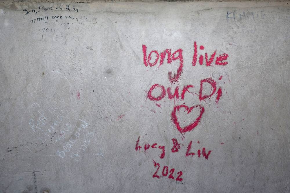 A tribute is written in memory of the late Princess Diana near the Liberty Flame monument above the tunnel of the Alma bridge where Diana Princess of Wales died in a car accident on August 31, 1997, in Paris, France, August 31, 2022. — Reuters pic
