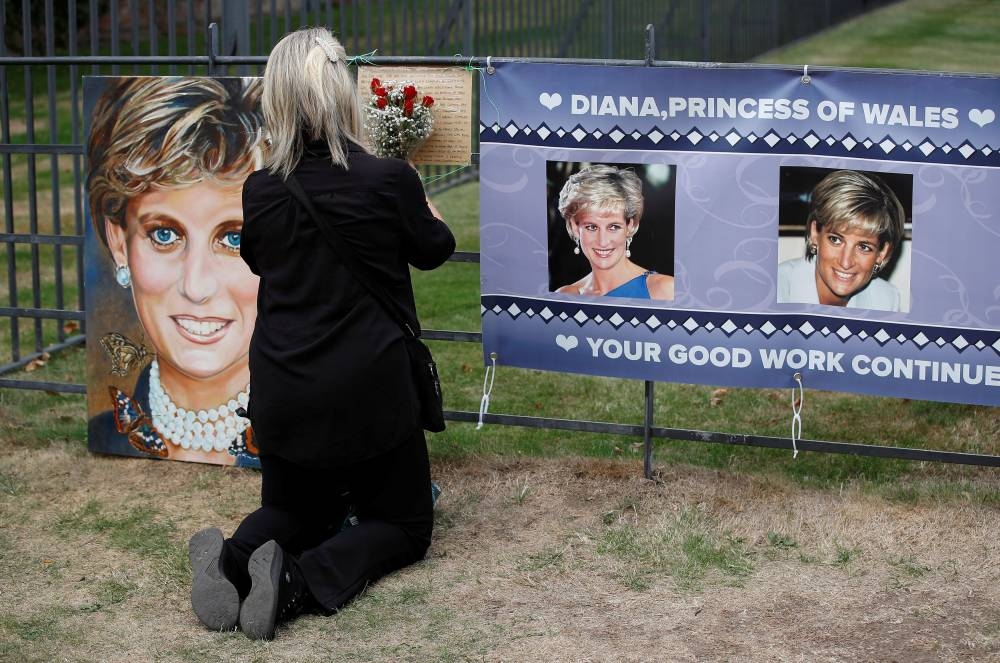 A person places flowers in a tribute to Princess Diana, on the 25th anniversary of her death, outside Kensington Palace, in London, Britain, August 31, 2022. — Reuters pic