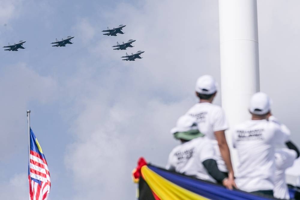 RMAF jets fly in formation in conjunction with the 2022 National Day celebrations at Dataran Merdeka, Kuala Lumpur, August 31, 2022. — Picture by Hari Anggara