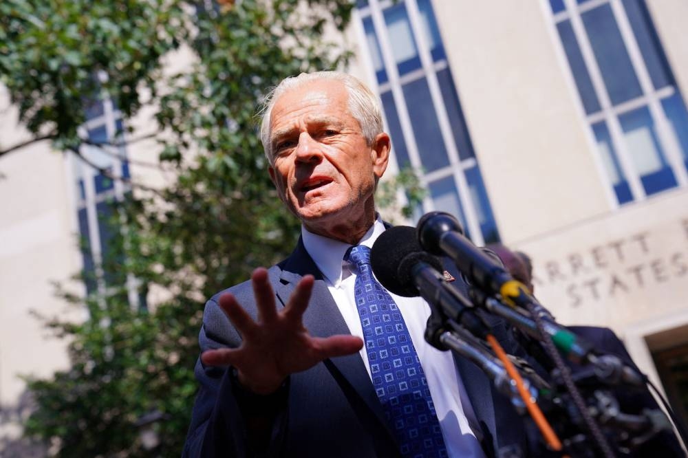 Peter Navarro, adviser to former US President Donald Trump, speaks to members of the media after a motion hearing in his contempt of Congress trial for refusing to cooperate with the House of Representatives committee investigating the January 6, 2021 attack on the US Capitol, at US District Court in Washington August 31, 2022. — Reuters pic