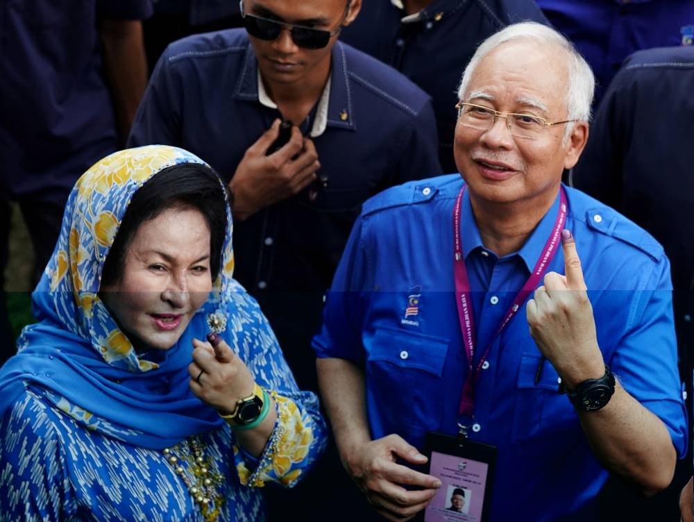 Najib and his wife, Datin Seri Rosmah Mansor, pose for photographers after voting in the 14th Malaysian general election, in Pekan, May 9, 2018. — Reuters pic