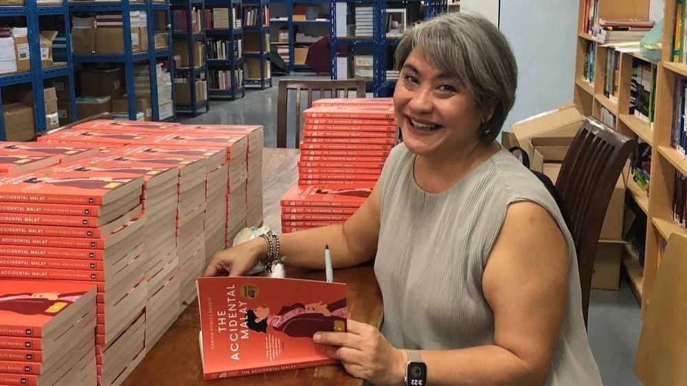 Epigram Book Prize 2022 winner, Karina Robles Bahrin, signing copies of her debut novel, ‘The Accidental Malay’. —  Picture by Karina Robles Bahrin
