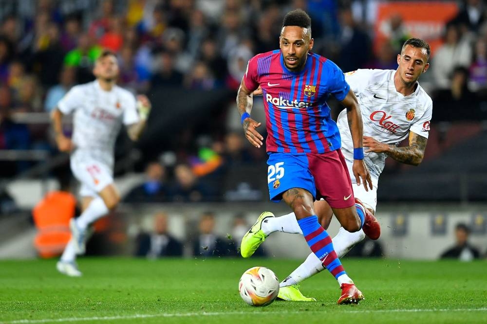 In this file photo taken on May 1, 2022 Barcelona's Gabonese midfielder Pierre-Emerick Aubameyang is challenged by Real Mallorca's Argentinian defender Franco Russo (right) during the Spanish League football match between FC Barcelona and RCD Mallorca at the Camp Nou stadium in Barcelona. — AFP pic