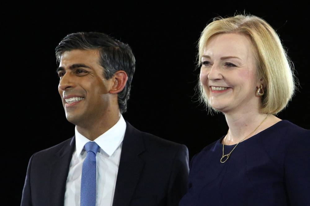 Rishi Sunak, Britain’s former Chancellor of the Exchequer (left) and Britain’s Foreign Secretary Liz Truss, the final two contenders to become the country's next Prime Minister and leader of the Conservative party, stand together on stage during the final Conservative Party Hustings event at Wembley Arena, in London, on August 31, 2022. — AFP pic