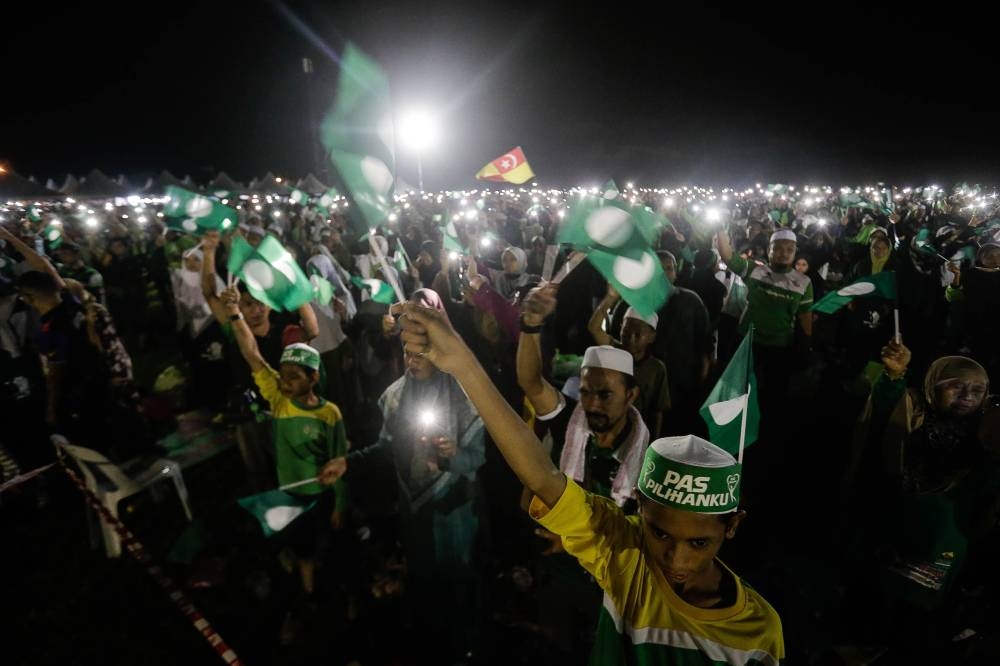 Supporters wave PAS flags during the launch of the party’s election machinery at the Kedah PAS Complex in Kota Sarang Semut on September 4, 2022. — Picture by Sayuti Zainudin
