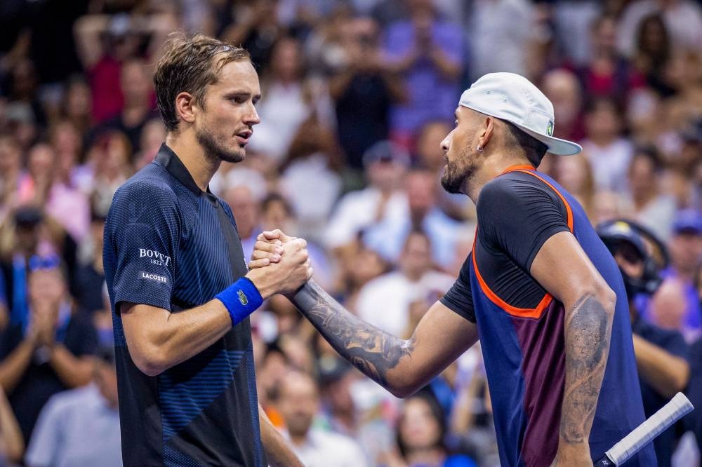 Russia's Daniil Medvedev congratulates Australia's Nick Kyrgios after their 2022 US Open Tennis tournament men's singles Round of 16 match in New York September 4, 2022. — AFP pic