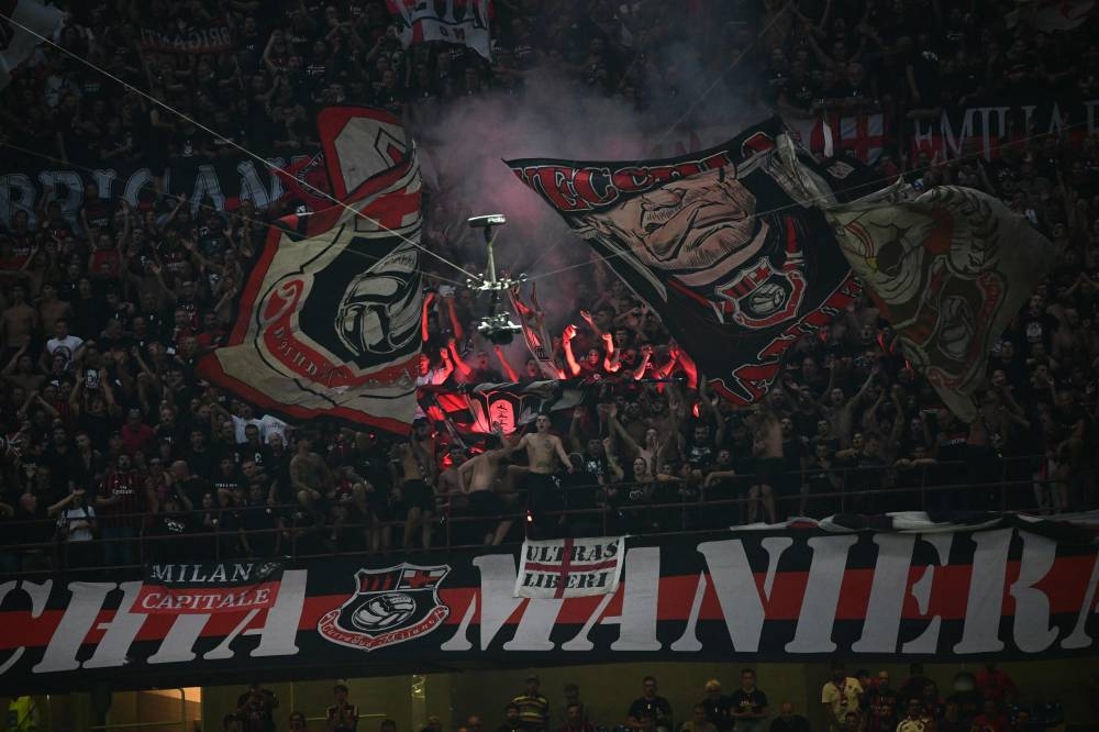 AC Milan’s supporters celebrate victory after the Italian Serie A football match between AC Milan and Inter Milan at the San Siro stadium in Milan, September 3, 2022. — AFP pic 