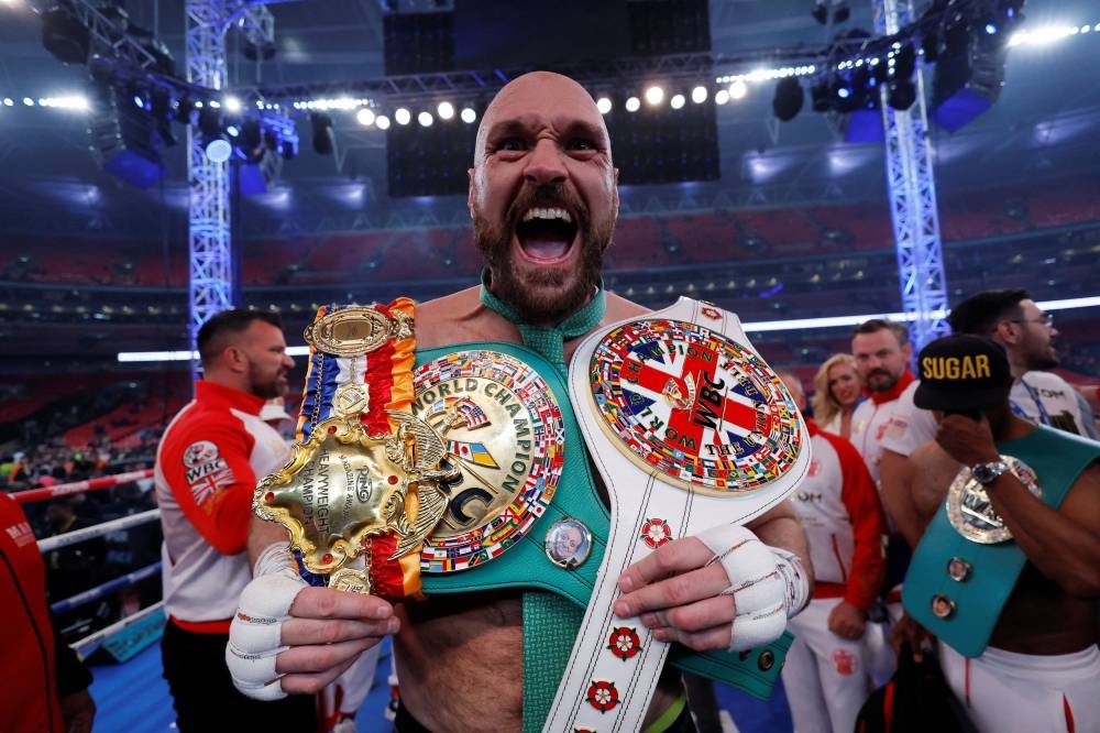 Tyson Fury celebrates with the belts after winning his fight against Dillian Whyte at the Wembley Stadium, London April 23, 2022. — Reuters pic 