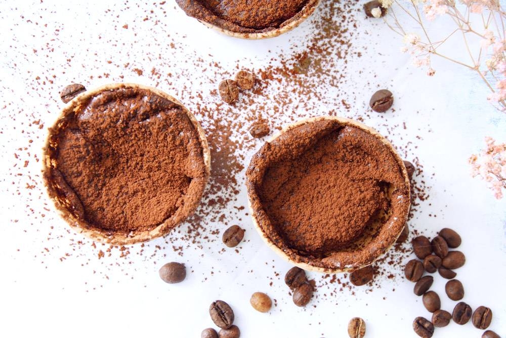 An intense dusting of cocoa powder deepens the chocolate flavour of the soufflés.