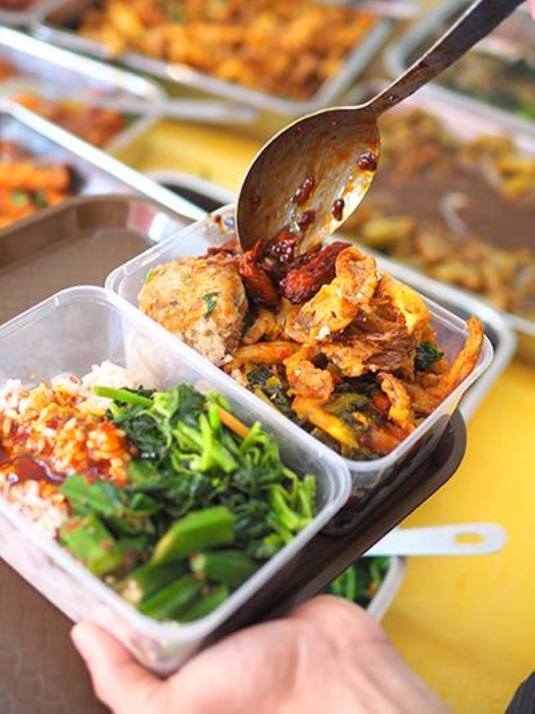 The boxes are filled to the brim with various vegetarian dishes for a meat-free meal at home or the office.