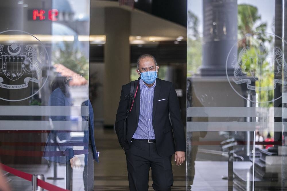 AmBank’s cheque processing centre senior manager Badrul Hisam Mohamad leaves the Kuala Lumpur High Court, September 7, 2022. — Picture by Hari Anggara
