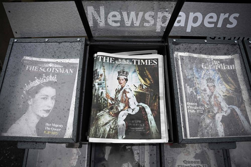 A photograph taken September 9, 2022, shows the front pages of British newspapers on display for sale in Edinburgh, a day after Queen Elizabeth II died at the age of 96. — AFP pic