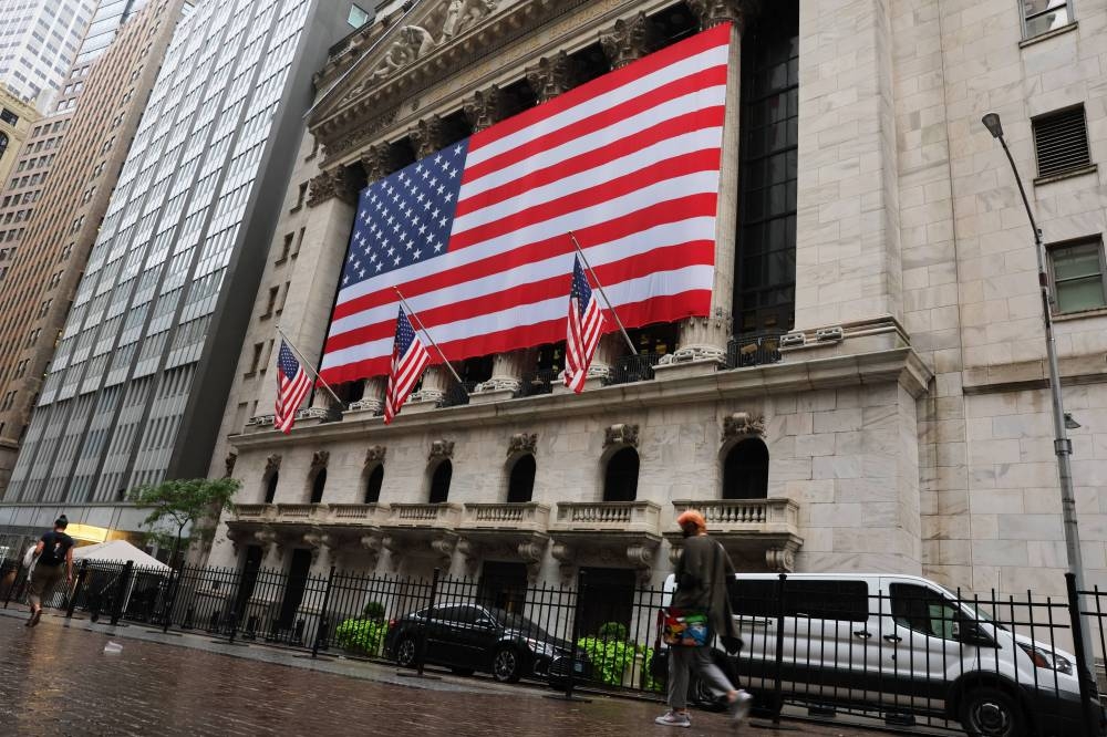People walk past the the New York Stock Exchange before the start of morning trading on September 06, 2022 in New York City. — AFP pic