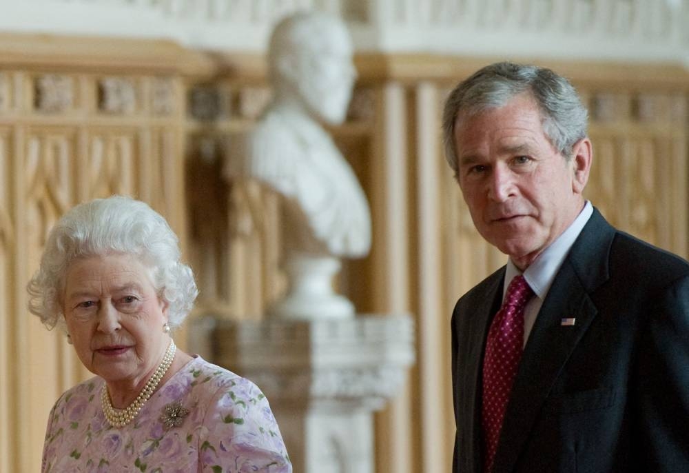 In this file photo taken on June 14, 2008, Britain's Queen Elizabeth II and US President George W. Bush tour St. George's Hall at Windsor Castle, in Windsor, Berkshire, west of London. — AFP pic