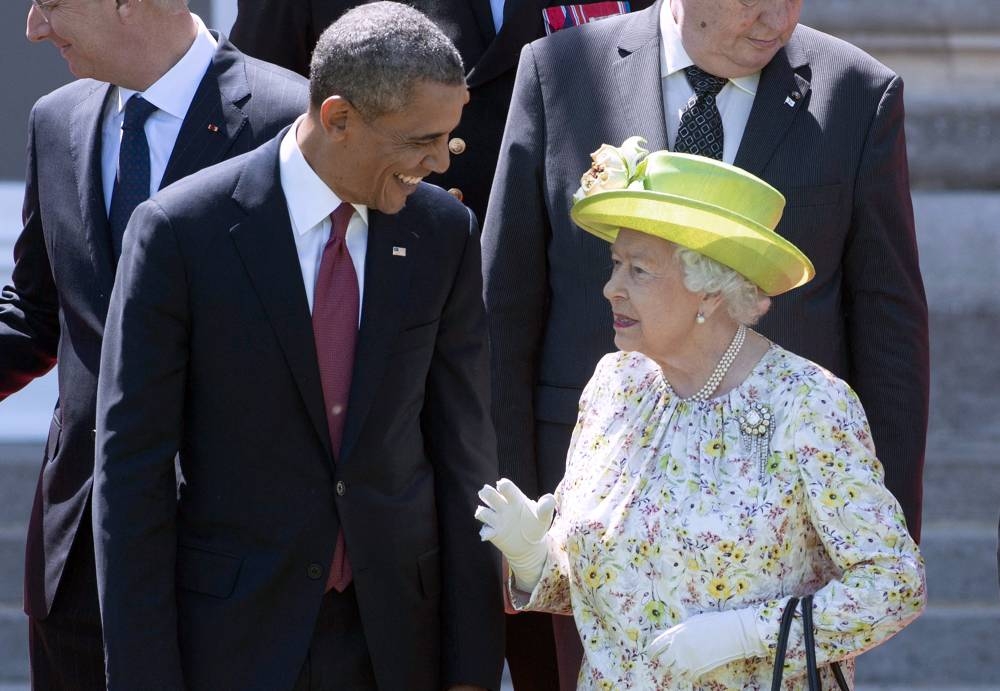 In this file photo taken on June 06, 2014, Queen Elizabeth II speaks with US President Barack Obama during a group photo of world leaders attending the D-Day 70th Anniversary ceremonies at Chateau de Benouville in Benouville, France. — AFP pic
