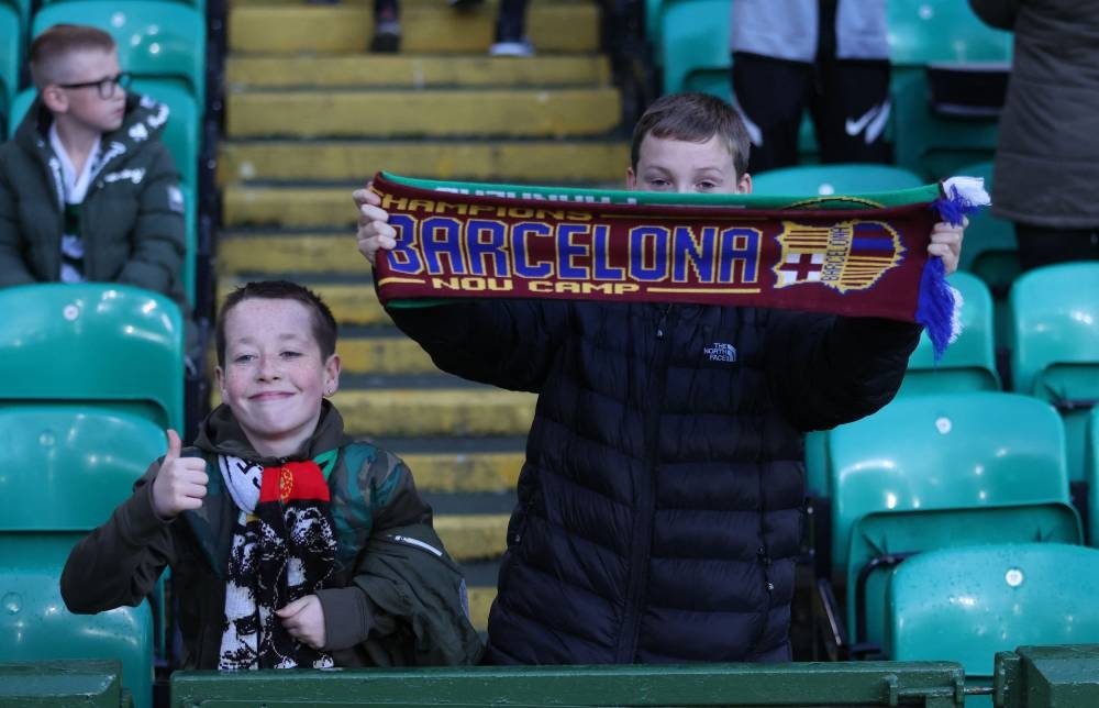 A young Celtic fan with an FC Barcelona scarf before the match against Real Madrid at Celtic Park, Glasgow September 6, 2022. — Reuters pic