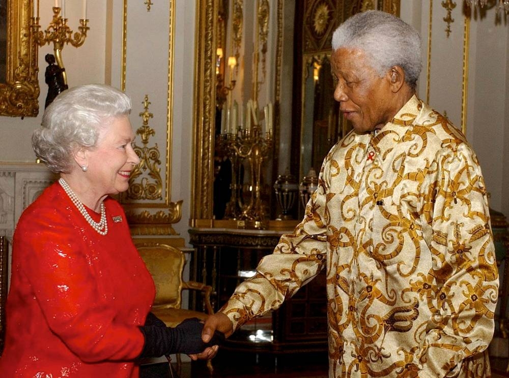 Britain’s Queen Elizabeth II (left) greets former South African President Nelson Mandela during a reception at Buckingham Palace, London, October 20, 2003, to mark the centenary of the Rhodes Trust. ― Reuters pic